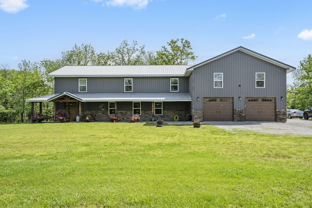 view of front of property featuring a garage, a front lawn, driveway, and stone siding