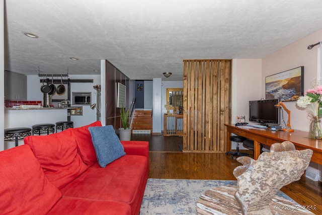 living area with visible vents and wood finished floors