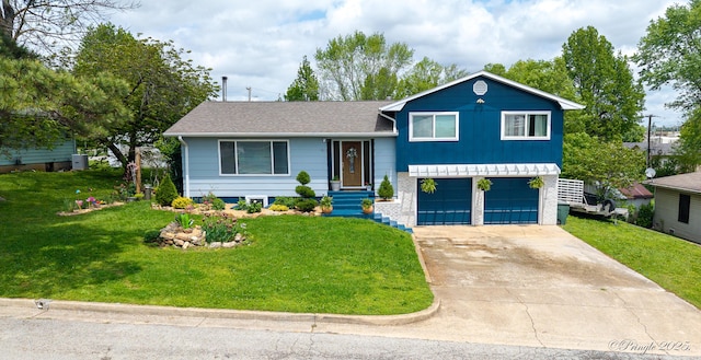 tri-level home with an attached garage, driveway, and a front lawn