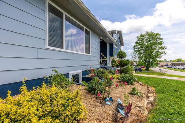 view of home's exterior with a lawn