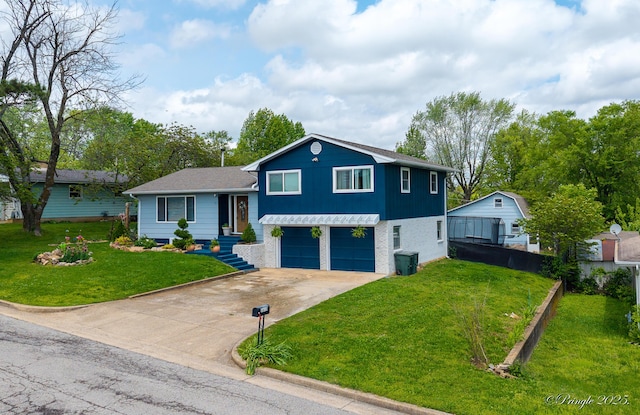tri-level home with concrete driveway, a garage, and a front lawn