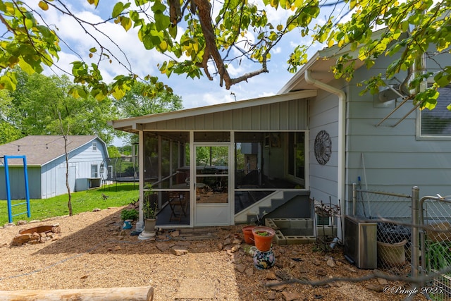 property entrance with a yard and fence