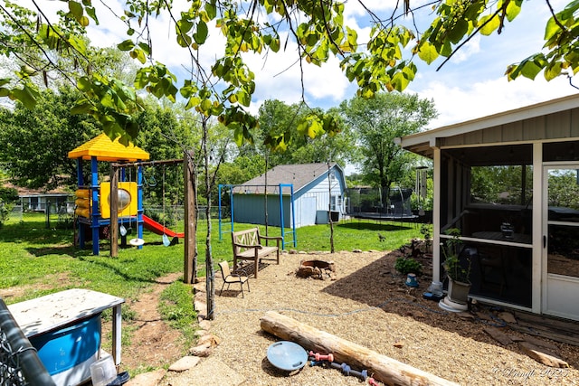 view of jungle gym featuring a lawn, a trampoline, a shed, and fence