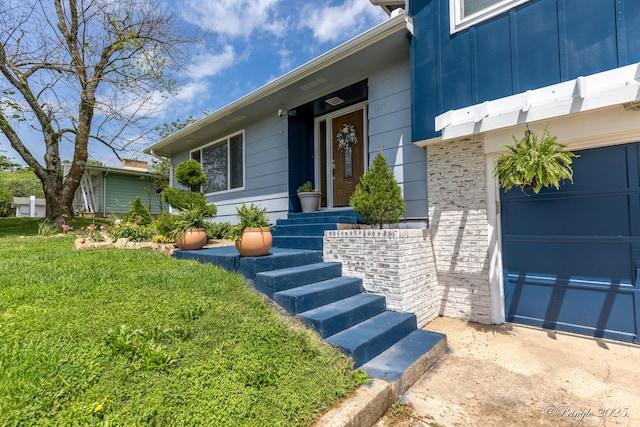 entrance to property with a garage and board and batten siding