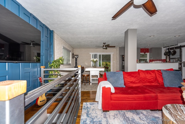 living area with ceiling fan and wood finished floors