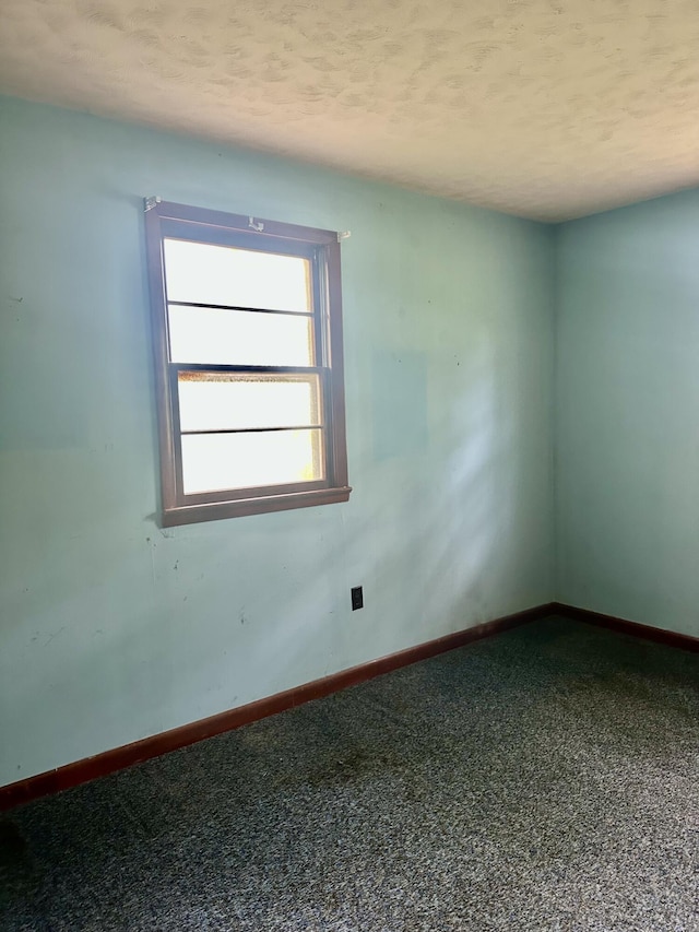 carpeted empty room with baseboards