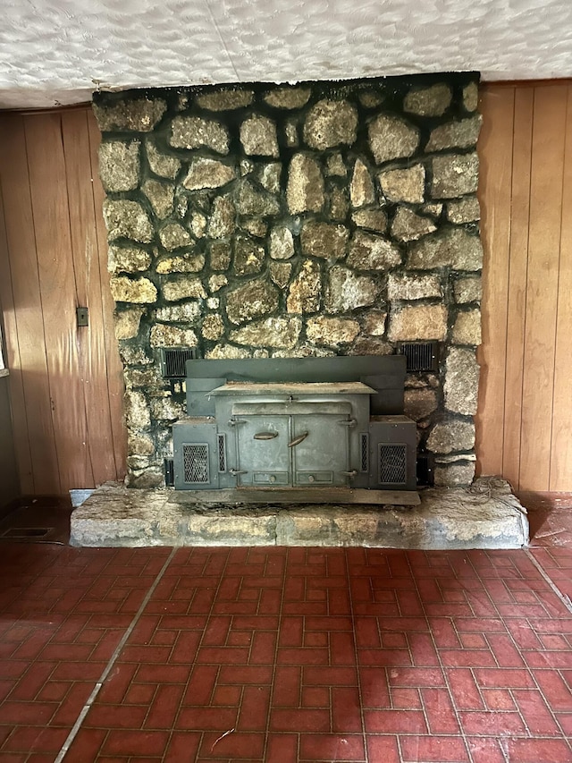 interior details with wood walls and a wood stove
