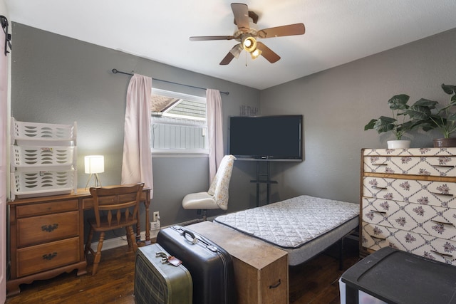 bedroom featuring a ceiling fan and dark wood-type flooring