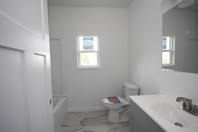 bathroom with a healthy amount of sunlight, vanity, toilet, and marble finish floor