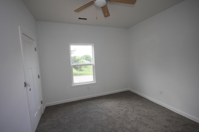 spare room with carpet floors, ceiling fan, visible vents, and baseboards