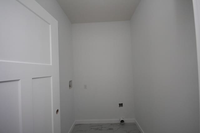 clothes washing area featuring laundry area, electric dryer hookup, baseboards, and marble finish floor