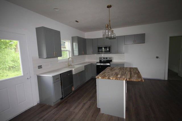 kitchen with gray cabinetry and stainless steel microwave