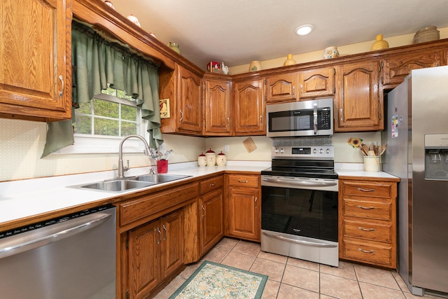 1730 N Pine St, Marshfield, MO 65706 - kitchen featuring light countertops, a sink, brown cabinets, and stainless steel appliances