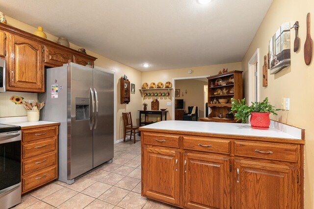 1730 N Pine St, Marshfield, MO 65706 - kitchen with light countertops, brown cabinets, open shelves, and appliances with stainless steel finishes