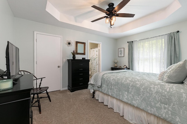 1730 N Pine St, Marshfield, MO 65706 - bedroom with baseboards, a ceiling fan, a tray ceiling, and light colored carpet