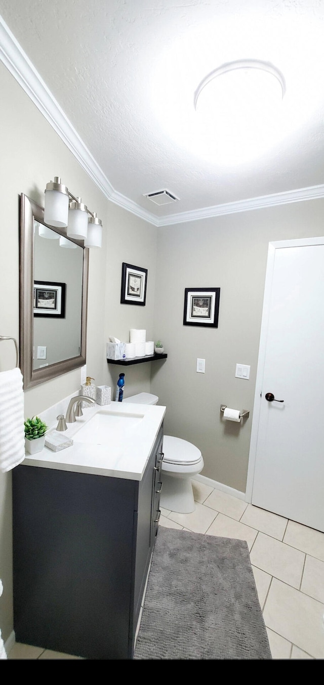 bathroom featuring vanity, ornamental molding, tile patterned floors, and toilet