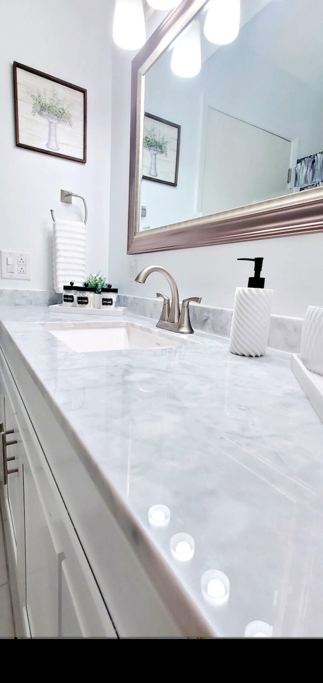 full bathroom featuring a sink and double vanity
