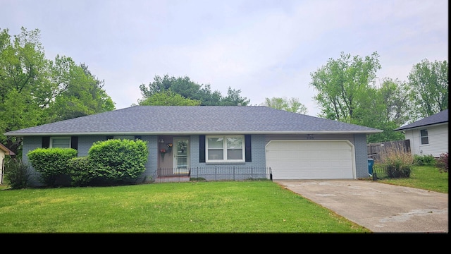 ranch-style home with brick siding, a garage, a front lawn, and concrete driveway