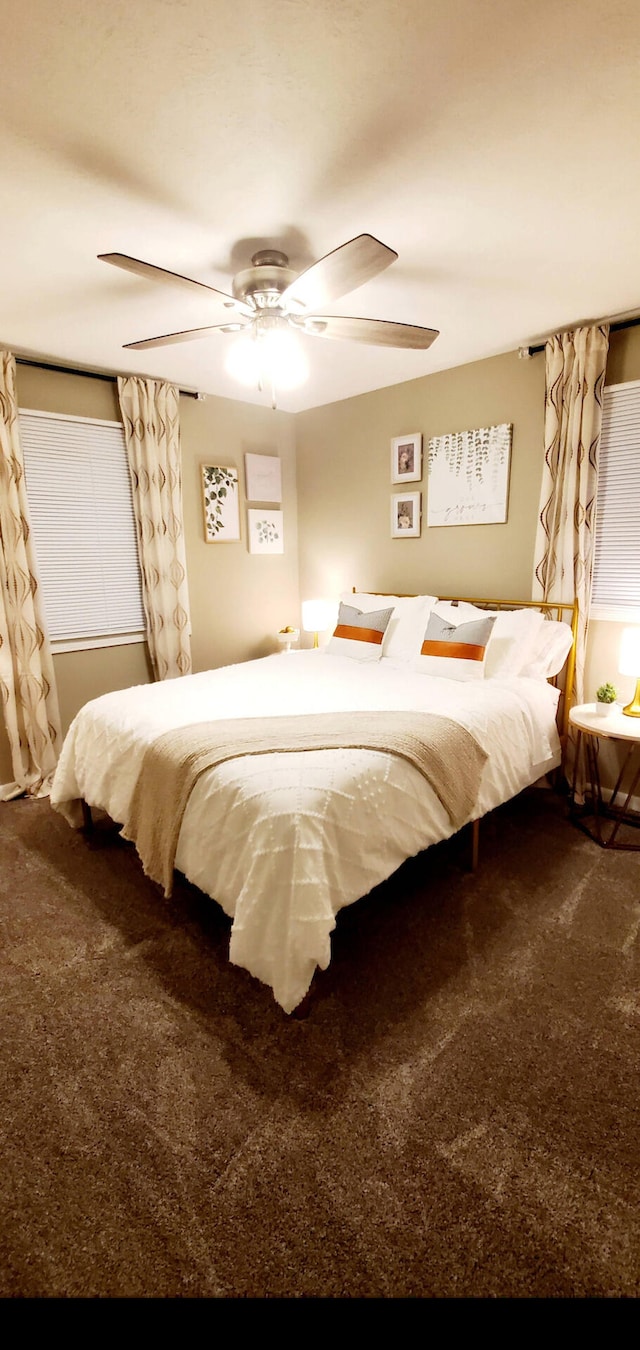 bedroom with a ceiling fan and carpet flooring