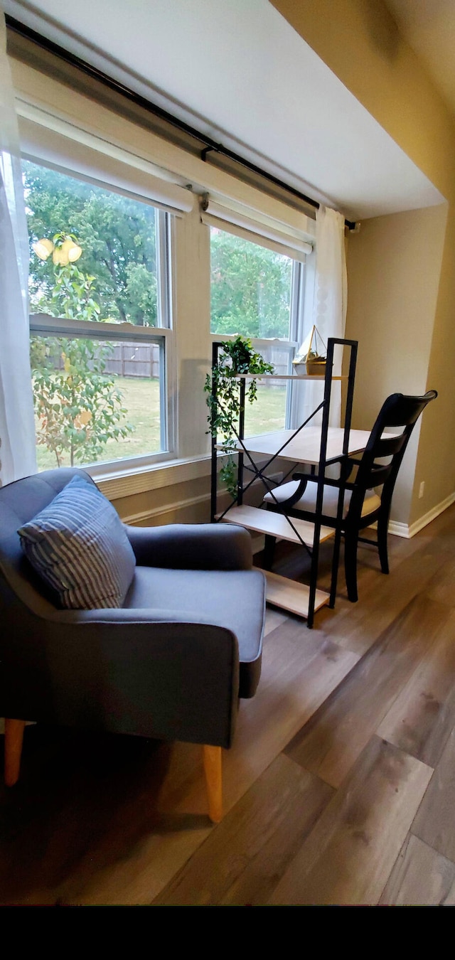 sitting room with baseboards and wood finished floors