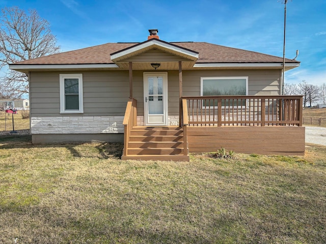 15481 Heron B Dr, Neosho, MO 64850 - view of front facade with a chimney, roof with shingles, stone siding, and a front yard