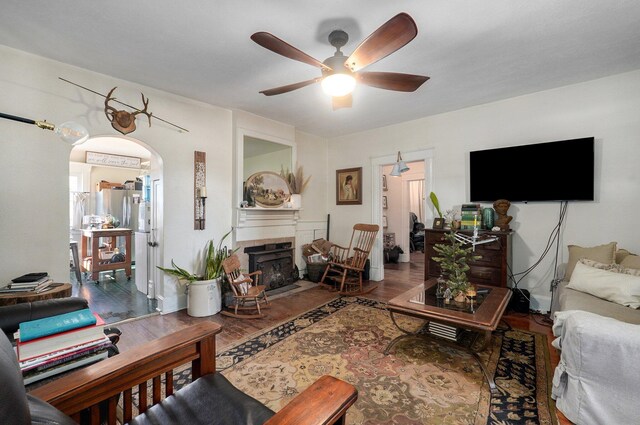 1487 E Lelia Ln, Springfield, MO 65803 - living room featuring a ceiling fan, arched walkways, wood finished floors, and a tile fireplace