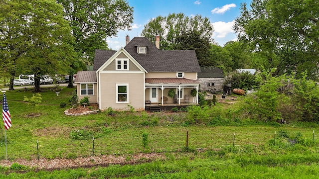 1487 E Lelia Ln, Springfield, MO 65803 - back of property featuring a lawn, a chimney, a porch, and metal roof