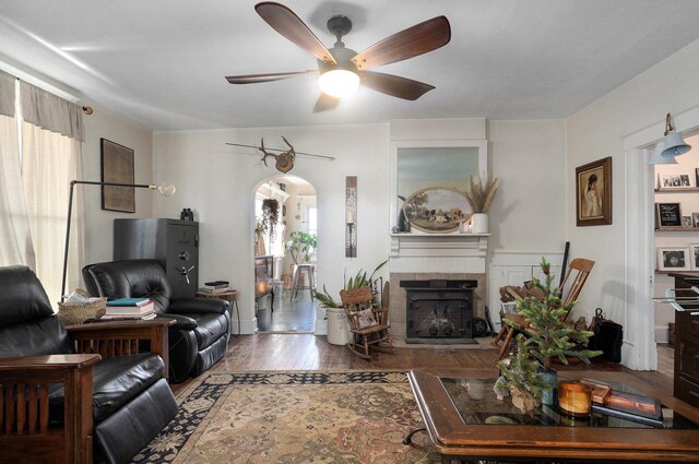 1487 E Lelia Ln, Springfield, MO 65803 - living room with a ceiling fan, arched walkways, wood finished floors, and a fireplace