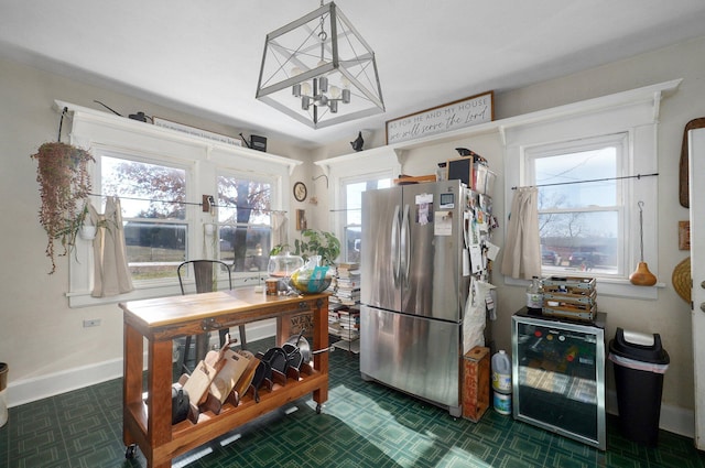 1487 E Lelia Ln, Springfield, MO 65803 - kitchen featuring beverage cooler, freestanding refrigerator, baseboards, and an inviting chandelier