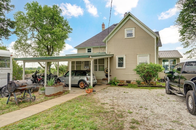 1487 E Lelia Ln, Springfield, MO 65803 - back of property featuring crawl space, a chimney, a shingled roof, and a carport