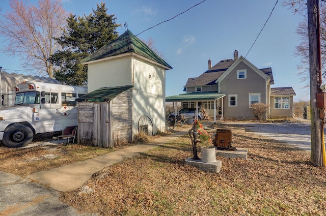 1487 E Lelia Ln, Springfield, MO 65803 - view of front of property with a storage unit, covered porch, and an outdoor structure