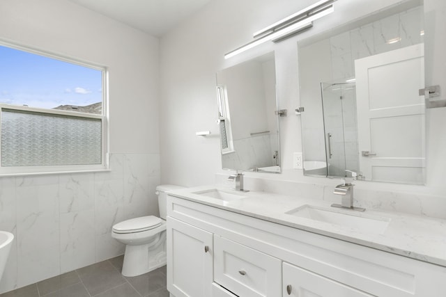 635 W Bridgewood Ct, Springfield, MO 65803 - bathroom featuring toilet, a marble finish shower, tile walls, tile patterned flooring, and double vanity