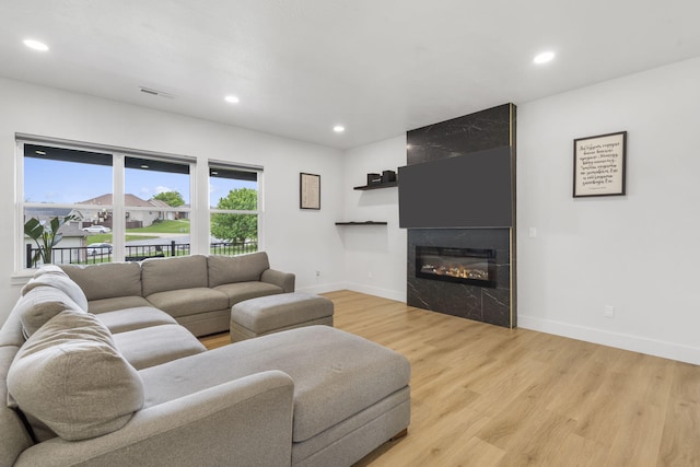 635 W Bridgewood Ct, Springfield, MO 65803 - living room with baseboards, light wood-style floors, a large fireplace, and recessed lighting