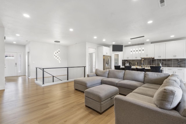 635 W Bridgewood Ct, Springfield, MO 65803 - living room featuring recessed lighting, light wood-style floors, and baseboards