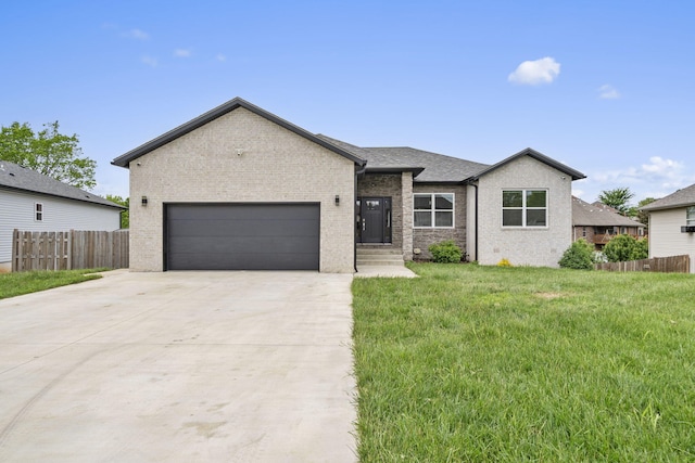 635 W Bridgewood Ct, Springfield, MO 65803 - view of front of house featuring a garage, brick siding, and driveway