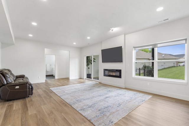 635 W Bridgewood Ct, Springfield, MO 65803 - living area featuring baseboards, light wood finished floors, recessed lighting, and a glass covered fireplace