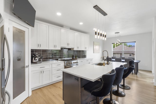 635 W Bridgewood Ct, Springfield, MO 65803 - kitchen with a sink, stainless steel appliances, a chandelier, tasteful backsplash, and white cabinets