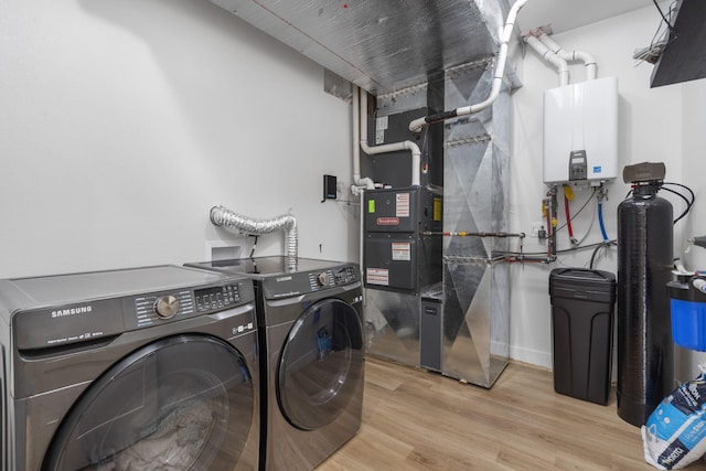 635 W Bridgewood Ct, Springfield, MO 65803 - laundry area featuring independent washer and dryer, wood finished floors, tankless water heater, and heating unit