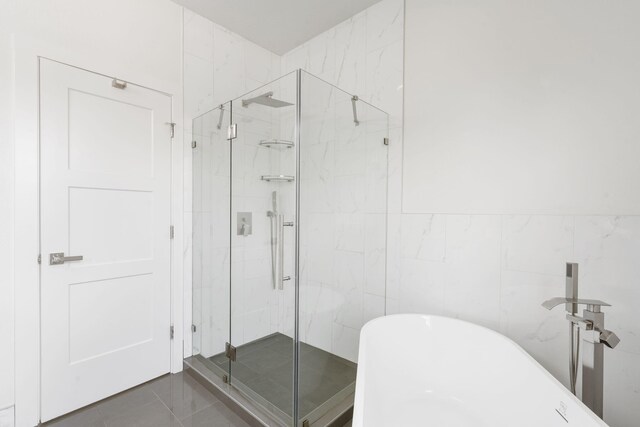 635 W Bridgewood Ct, Springfield, MO 65803 - bathroom with a freestanding bath, a marble finish shower, and tile walls