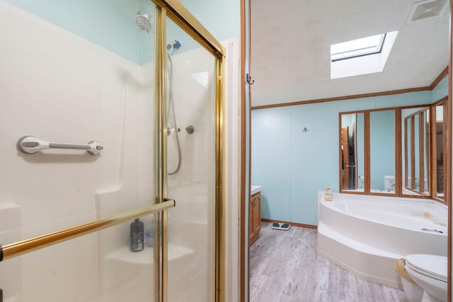 bathroom featuring visible vents, a skylight, a shower stall, wood finished floors, and toilet