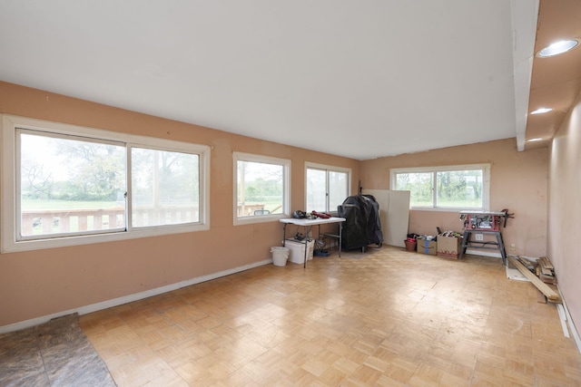 office space with baseboards and vaulted ceiling