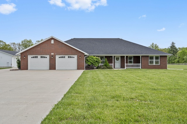 single story home with concrete driveway, brick siding, an attached garage, and a front lawn