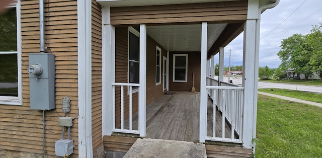 entrance to property with a yard and covered porch
