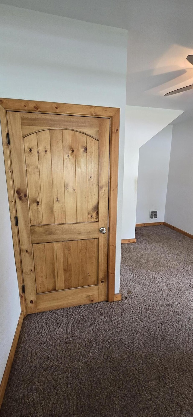 interior details featuring carpet floors, baseboards, visible vents, and ceiling fan