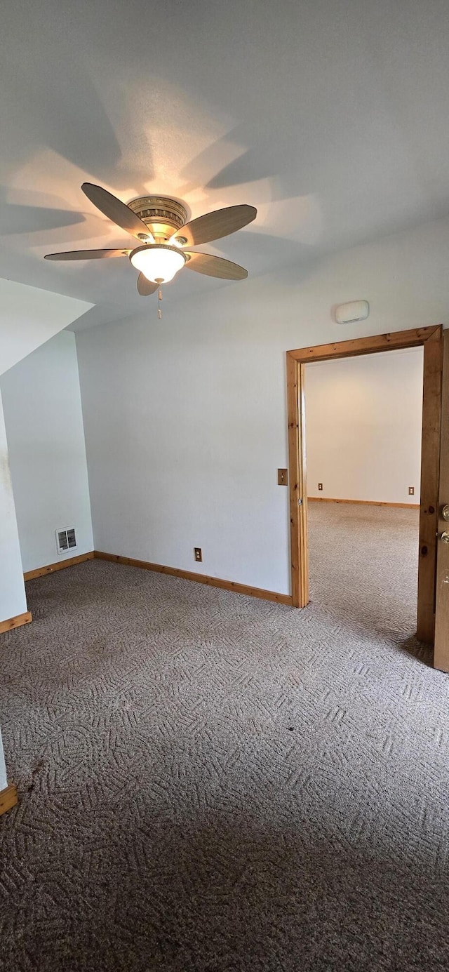 unfurnished room featuring carpet floors, a ceiling fan, baseboards, and visible vents
