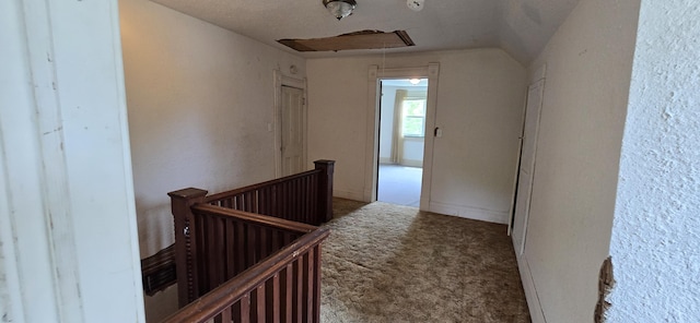 hall featuring carpet floors, attic access, and an upstairs landing