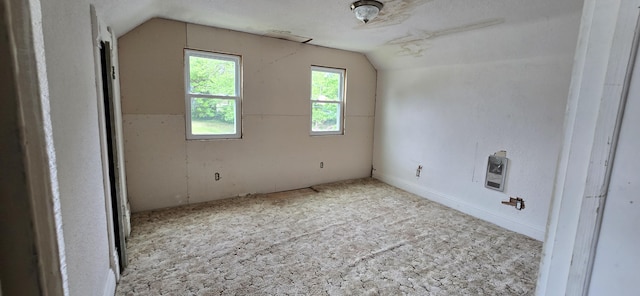 unfurnished room featuring carpet floors and lofted ceiling