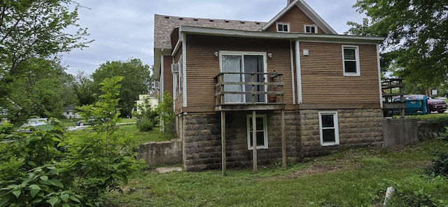 back of property featuring a shingled roof