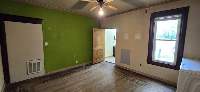 unfurnished room with visible vents, wood finished floors, and a healthy amount of sunlight