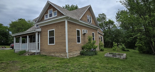 view of side of home with a lawn and an AC wall unit